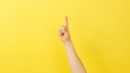 woman hand showing ok gesture over yellow background. index finger hand on sign language background