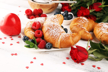 Wall Mural - Delicious breakfast with fresh croissants and ripe berries and mint for valentines day