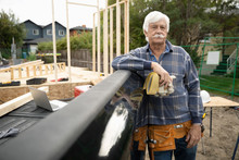 Portrait Confident Senior Man Working At Construction Site, Leaning On Truck