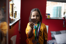 Portrait Confident Soccer Boy In Uniform Showing Medal