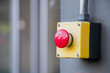 © MemoryMan - Red Reset button on the wall. red emergency stop switch button in a factory building.