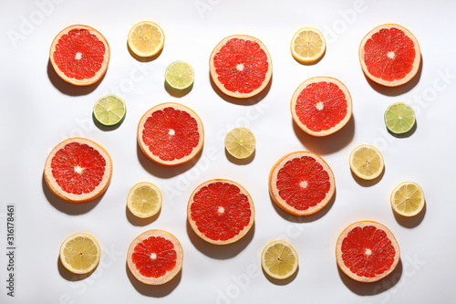 Fotografía Flat lay composition with tasty ripe grapefruit slices on white background