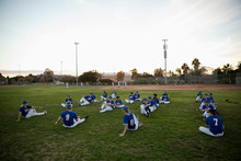 Baseball Players Stretching In Grass