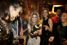 Portrait Confident Bachelorette And Friends With Kissing Sign And Jar In Nightclub