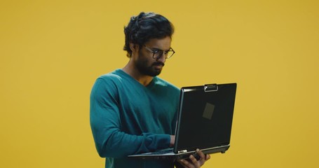 Young man typing on laptop