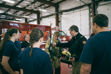 Firefighters Meeting, Checking Equipment In Fire Station