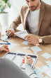© LIGHTFIELD STUDIOS - Selective focus of creative designers planning wireframe sketches for mobile website at table