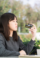 Close up young woman holding credit card