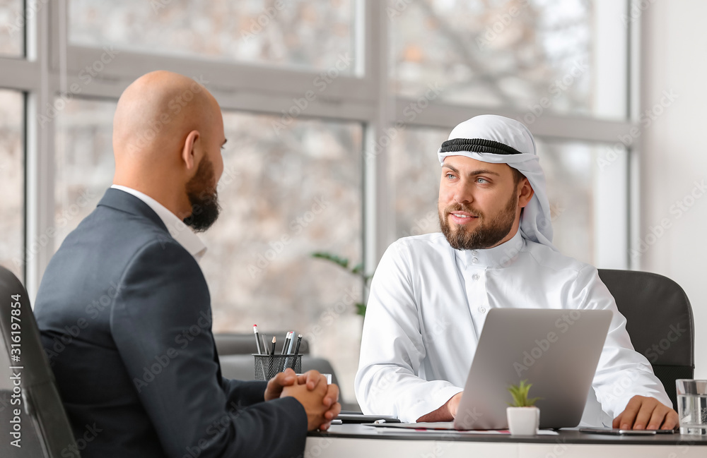 Arab man and his business partner in office