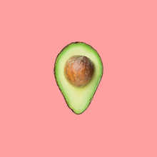 Raw Ripe Halved Avocado With Pit Isolated On Pink Background. Creative Food Poster Banner For Culinary Cooking Oil Healthy Lifestyle Natural Cosmetics Concept