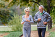 © lordn - Cheerful active senior couple jogging in the park. Exercise together to stop aging.