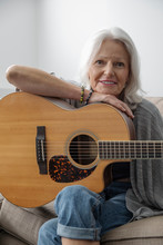 Portrait Smiling Senior Woman Playing Guitar