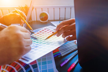 Wall Mural - a team of web designers are working together to develop a mobile responsive website with ui / ux fro