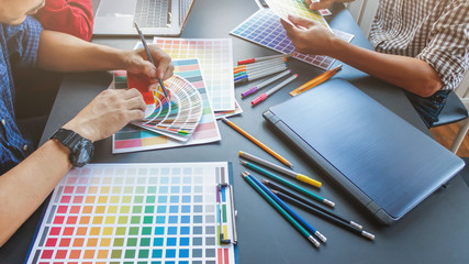 Wall Mural - a team of web designers are working together to develop a mobile responsive website with ui / ux fro