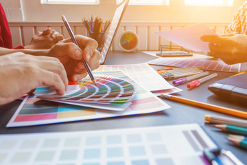 Wall Mural - a team of web designers are working together to develop a mobile responsive website with ui / ux fro