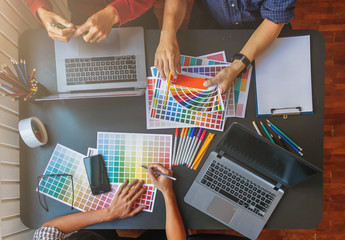 Wall Mural - a team of web designers are working together to develop a mobile responsive website with ui / ux fro