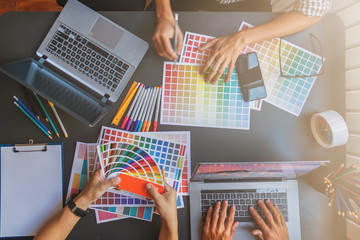 Wall Mural - a team of web designers are working together to develop a mobile responsive website with ui / ux fro