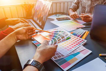 Wall Mural - a team of web designers are working together to develop a mobile responsive website with ui / ux fro