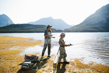 Mother And Son Fishing At Sunny, Scenic Lakeside
