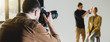 panoramic shot of photographer taking photo of model and hairstylist