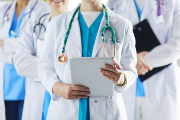 Group of doctors and nurses standing in the hospital room