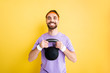 © LIGHTFIELD STUDIOS - cheerful bearded sportsman exercising with heavy dumbbell isolated on yellow
