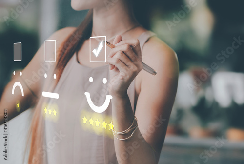 Cuadros en Lienzo Businesswoman pressing smiley face emoticon on virtual touch screen