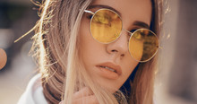 Portrait Of Beautiful Stylish Blonde Woman In Yellow Sunglasses In Outdoor.