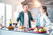 © Mirko Vitali - Young couple in love having fun at house kitchen - Happy millenial lovers enjoying lunch together at home on jubilee anniversary - Genuine relationship concept on bright indoor filter