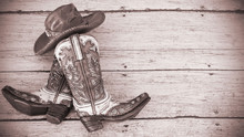 Cowboy Boots And Hat On A Wood Background With Vintage Tinted Effect And Writing Space