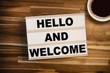Lightbox Or Light Box With Message Hello And Welcome On A Wooden Table