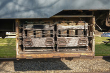 Battery Compartment With Removable Batteries Attached To The Undercarriage Of An Antique Railroad Train Car