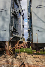 Two Old Rusted Antique Railroad Train Cars Coupled Together