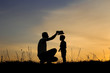 © Kostia - silhouette of father and son play on sunset