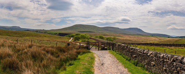 Wall Mural - Yorkshire Dales landscape with the Ribblehead Viaduct and Ingleborough in the background, seen from Blea Moor, North Yorkshire, England, UK