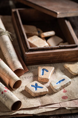 Antique rune stones with old manuscript and scrolls