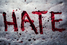 The Word Hate Painted By Blood On A Metal Table