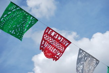 Colorful Mexican Flags In Blue Sky Background
