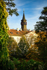 Wall Mural - Church in Prague, Praha, Czech Republic. The foreground is a tree changing color in autumn.