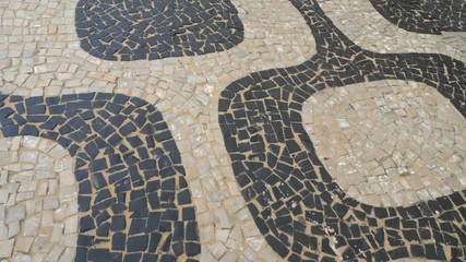 Wall Mural - Walking on famous Ipanema Beach stone sidewalk, Rio de Janeiro, Brazil