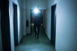 © Andrey Popov - Security Guard With Flashlight In Building Corridor