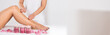 Beautician Waxing Woman's Leg At Salon
