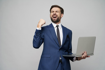 Young handsome businessman Holding a laptop Computer with Blank Screen