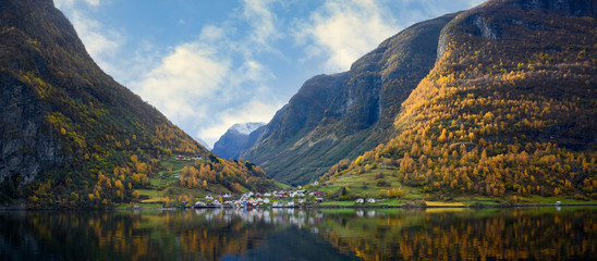 Sticker - The village of Undredal is a small village on the fjord. Aurlandsfjord West coast of Norway, High mountains and villages reflect in the water during autumn season.