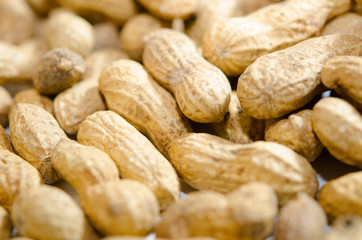 Unshelled peanuts close-up. Lots of nuts, vegan, natural food.