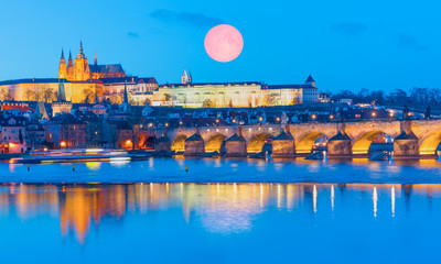 Wall Mural - Prague Castle and Charles Bridge, Prague, Czech Republic, Vltava river in foreground with full moon 