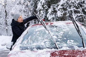 Woman Cleaning Car From Snow