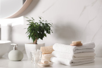 Wall Mural - Composition with soap dispenser and towels on white table indoors