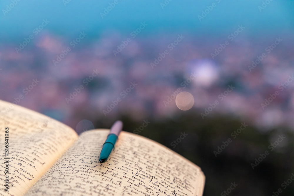 A journal notebook placed outdoors in open. selective focus. - obrazy, fototapety, plakaty 