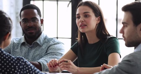 Wall Mural - Professional caucasian female employee engaged in multiracial team creative discussion